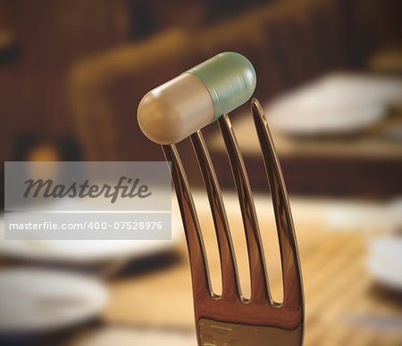 Inside the restaurant with a pill stuck in the fork. Concept of food supplement.