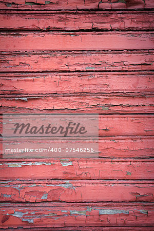 Peeling red paint on weathered wood texture