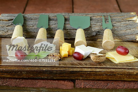 cheeseboard with assorted cheeses (parmesan, brie, blue, cheddar)