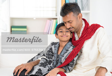 Portrait of Asian Indian father and son at home.