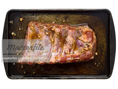 close up of a slab of rustic raw uncooked marinated pork ribs