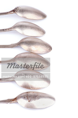 Frame of Old Silver Spoons In a Row isolated on white background