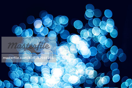 Blue bokeh light effect defocused circle patterns on dark background