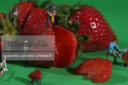 Miniature Construction Workers in Conceptual Food Imagery With Strawberries