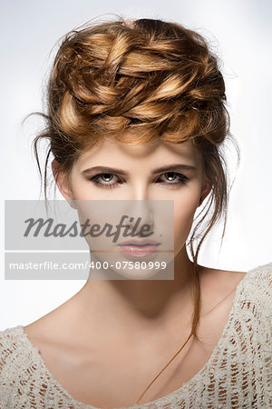 close-up shoot of pretty young girl with perfect skin, natural make-up and creative elegant hair-style