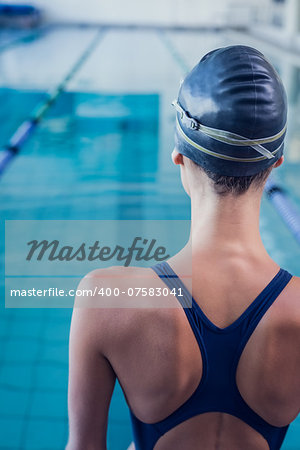 Pretty swimmer standing by the pool at the leisure center