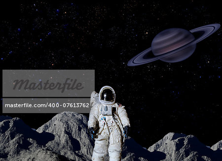 Astronaut on surface of Saturn's moon.