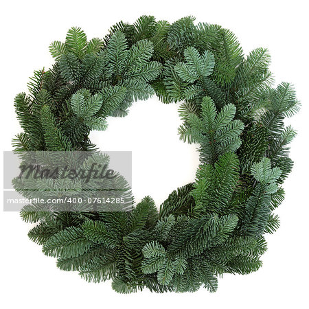 Christmas green spruce wreath over white background.