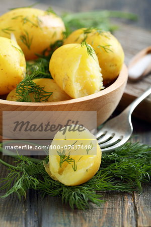 New potatoes with dill in a bowl closeup.
