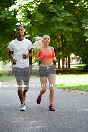 young couple runner jogger in park outdoor summer sport lifestyle