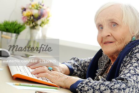 Close-up. Cute, elderly woman at the table
