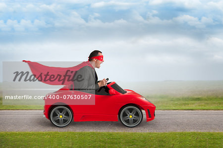 superhero man driving a red toy racing car at speed