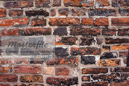 Old brick wall texture. Fragment of medieval wall in Gdansk, Poland. Architectural background.