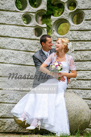 beautiful young wedding couple in park, blonde bride and her groom