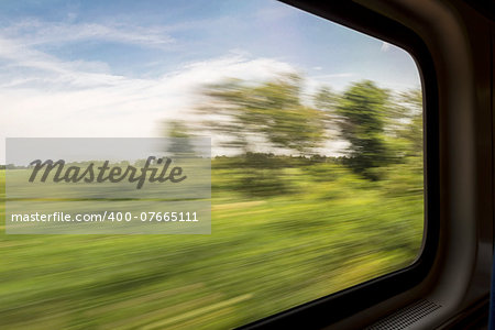 blurred abstract green landscape seen from a window train in motion - summer in Missouri