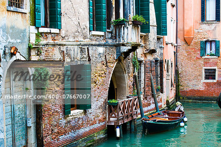 Old buildings and gondola on canal in Venice