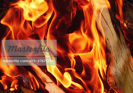 Detail of fire flames and wood background