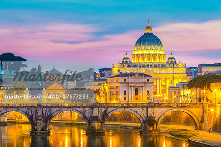 Night view of old roman Bridge of Hadrian and St. Peter's cathedral in Vatican City, Rome, Italy.