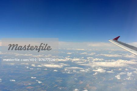 Airplane wing on a background of clouds