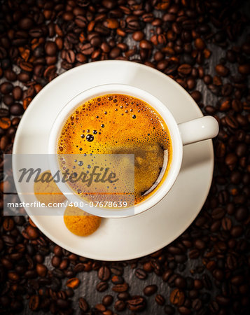 Espresso cup in coffee beans - top view