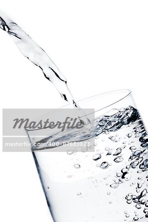 detail of filling a glass with pure water with bubbles on white background