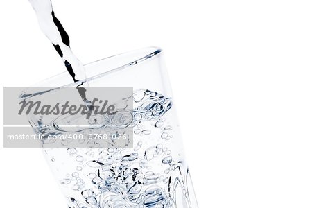 detail of filling a glass with pure water with bubbles and space for text on white background