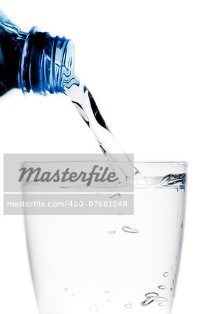 pouring a glass with water trough little blue bottle on white background