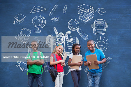 Cute pupils smiling at camera  against blue chalkboard with school doodles