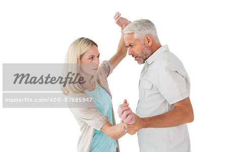 Angry man overpowering his partner on white background
