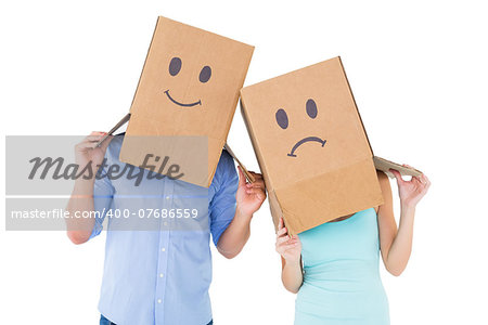 Couple wearing sad face boxes on their heads on white background