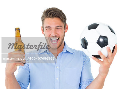 Handsome young man holding ball and beer on white background