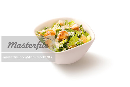 Traditional classic Caesar salad in a deep white plate