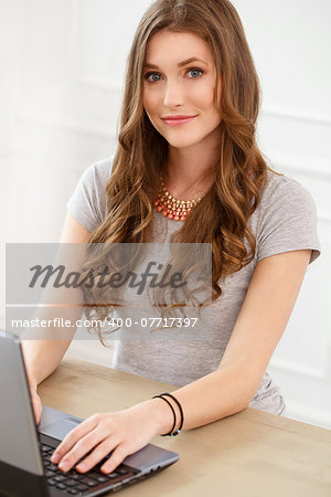 Student, office. Cute, beautiful woman by the table