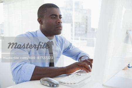 Focused businessman working at his desk in his office