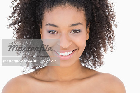 Pretty girl with afro hairstyle smiling at camera on white background