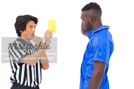 Referee showing yellow card to football player on white background