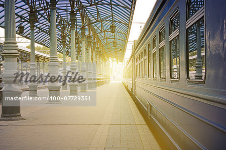Trains stand at the station at sunrise time.
