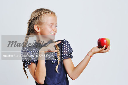 Portrait of pretty blond hair girl holding color apples.