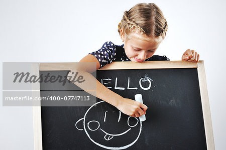 Smiling cute little girl being pacient with her drawings