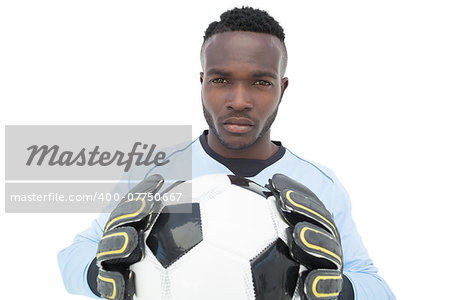 Portrait of a serious football player over white background