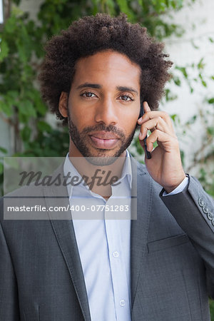 Handsome businessman on the phone on a sunny day