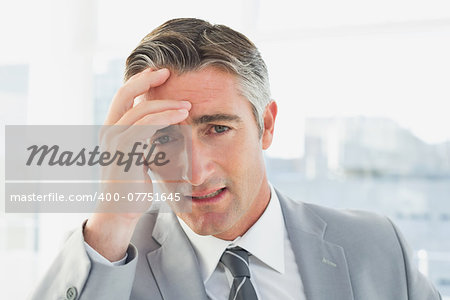 Businessman suffering from a headache at work