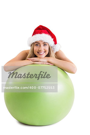 Festive fit blonde posing with exercise ball on white background