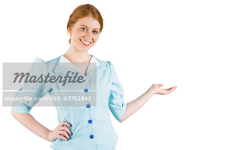 Pretty air hostess presenting with hand on white background