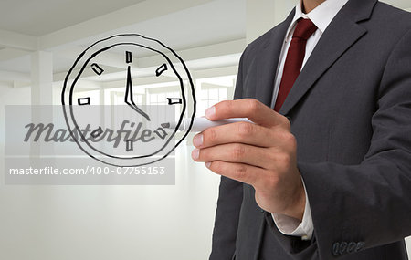 Composite image of business person drawing a black clock