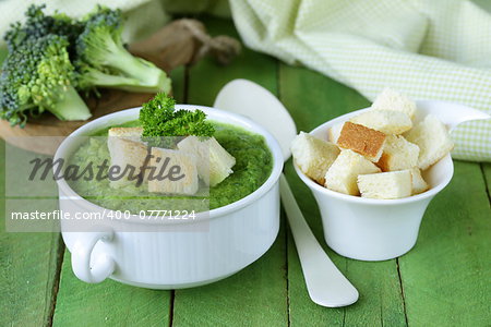 vegetable broccoli cream soup with white croutons and parsley