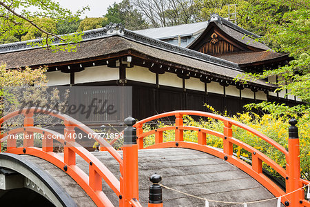 Orange arched bridge of Japanese temple garden in shimogamo-jinja, Kyoto, Japan