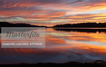 Spectacular cloud reflections on Narrabeen Lakes at sunrise.