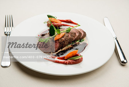 Roe deer fillet with vegetables, purple potato puree and red wine sauce