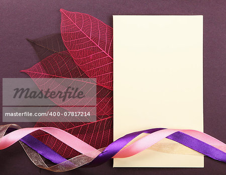 Empty greeting post card on violet cardboard background